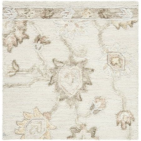 a white rug with an ornate design on it