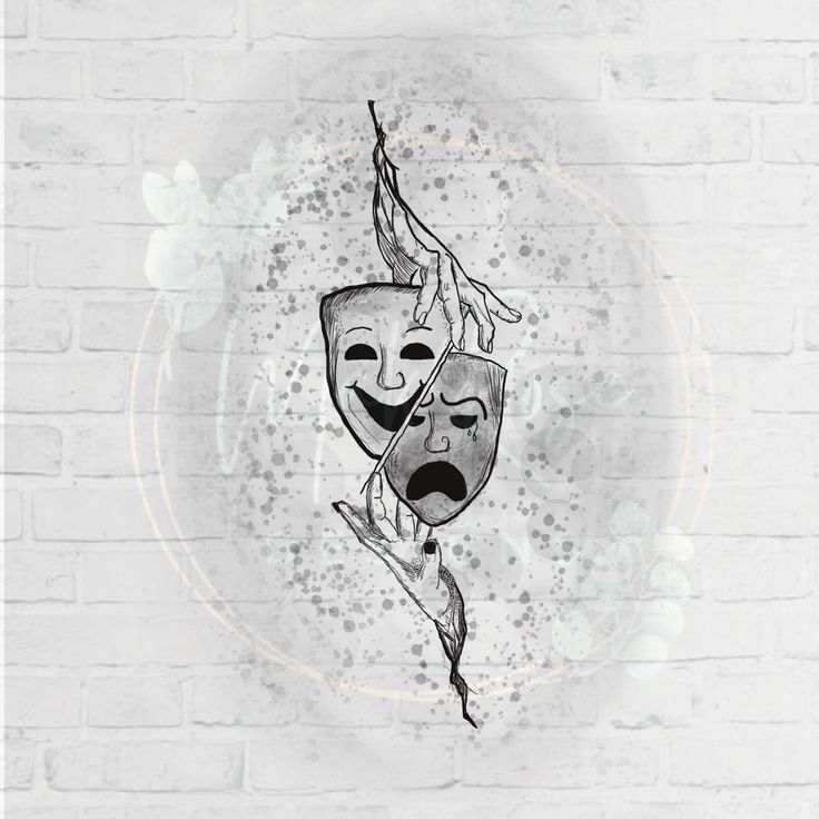 a white brick wall with a drawing of two masks on it