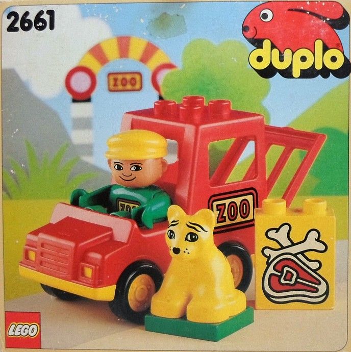 a toy truck with a dog and cat in it's back end, next to an advertisement for duplo