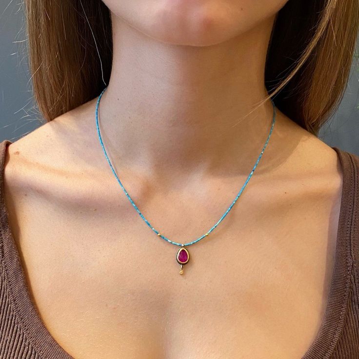 A luscious, rose cut ruby, glowing in warm a 22k gold bezel is accented with a tiny gold drop, and suspended on a delicate strand of earthy turquoise heishi beads. Two tiny 22k beads enhance the turquoise strand. This piece is an amazing combination of color and texture. Ruby measures approximately 3/8 inch tall. 14k gold clasp. Matte finish. Turquoise Beaded Necklace, Faceted Bead Necklace, Turquoise Bead Necklaces, Funky Jewelry, Rhodolite Garnet, Heishi Beads, Turquoise Beads, 22k Gold, Makeup Accessories