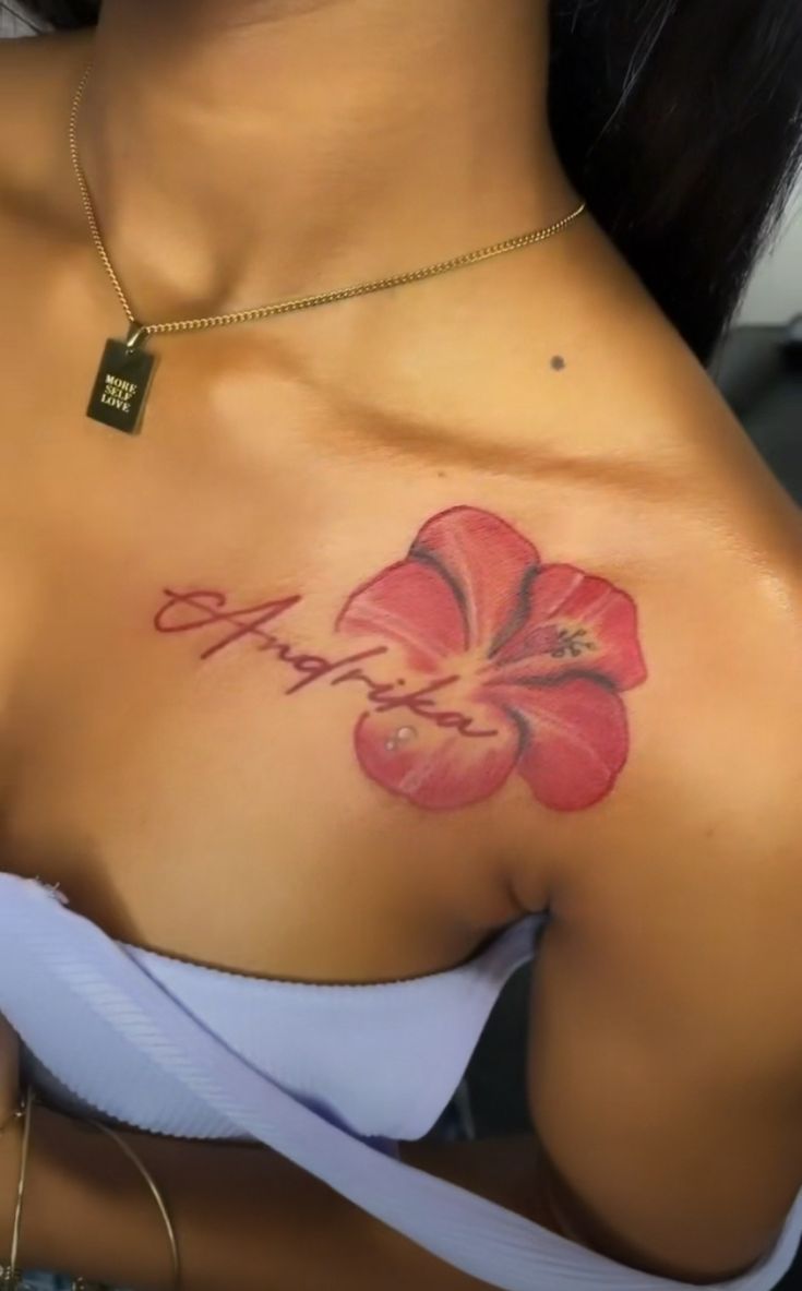 a woman with a flower tattoo on her chest