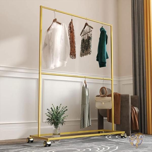 a mirror with clothes hanging on it in a room