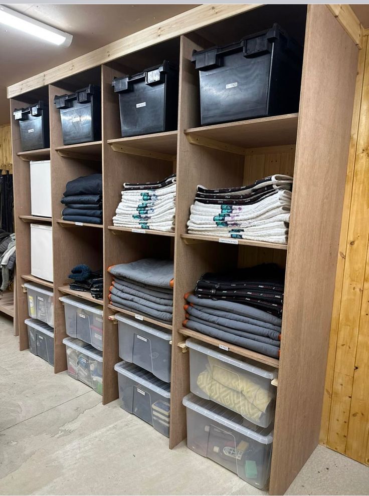 the shelves are filled with many different types of shirts and other items in bins