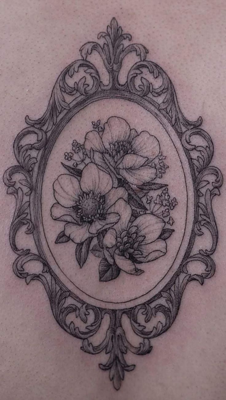 the back of a woman's chest with flowers in a frame on top of it