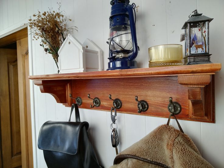 a wooden shelf with hooks and purses on it