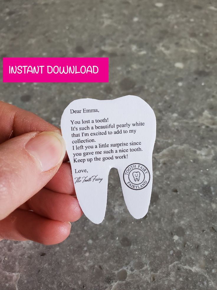 someone holding up a tooth shaped business card