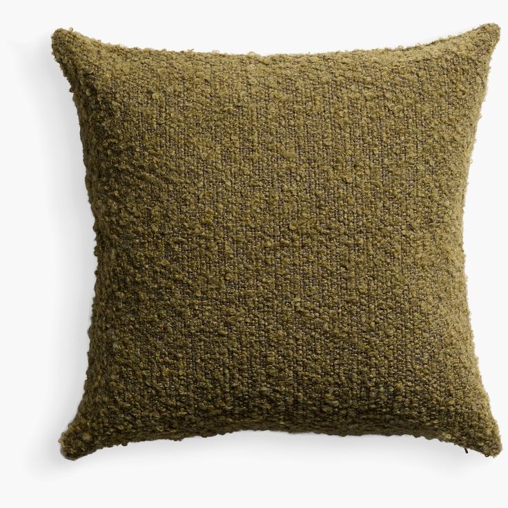 a green pillow with a textured design on the front and back, sitting on a white background