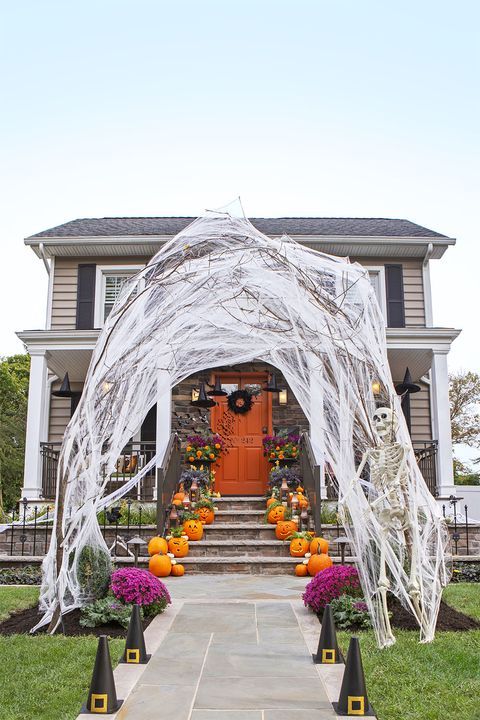 a house decorated for halloween with decorations and pumpkins