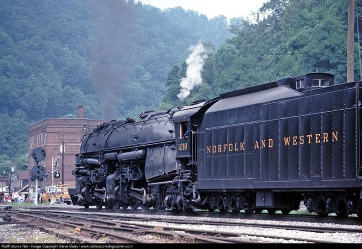 an old fashioned steam train on the tracks