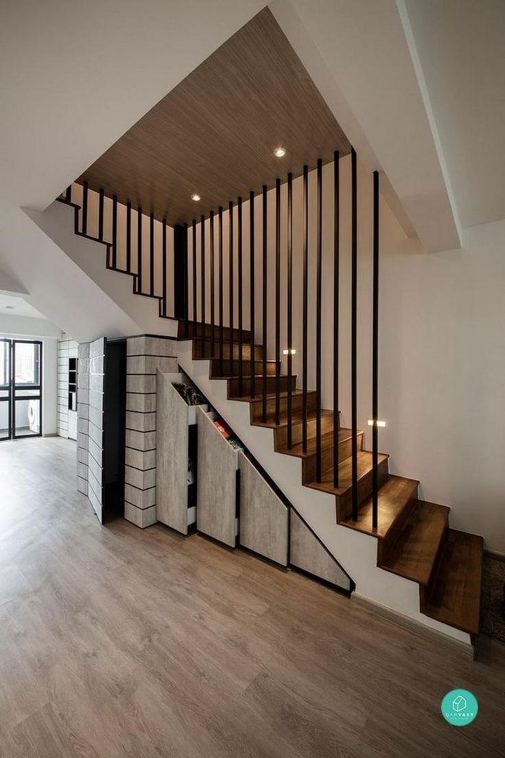 an empty room with wooden stairs and white walls