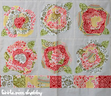 an image of a quilted table cloth with flowers and circles on it in red, green, yellow and white