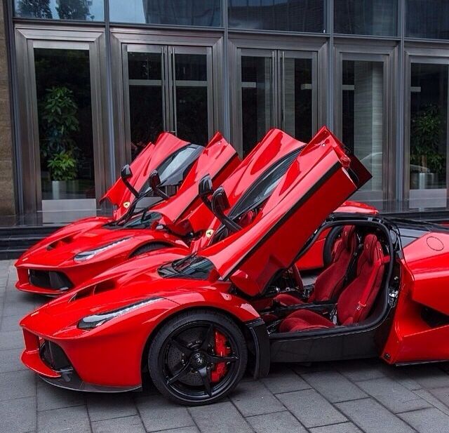 two red sports cars parked next to each other