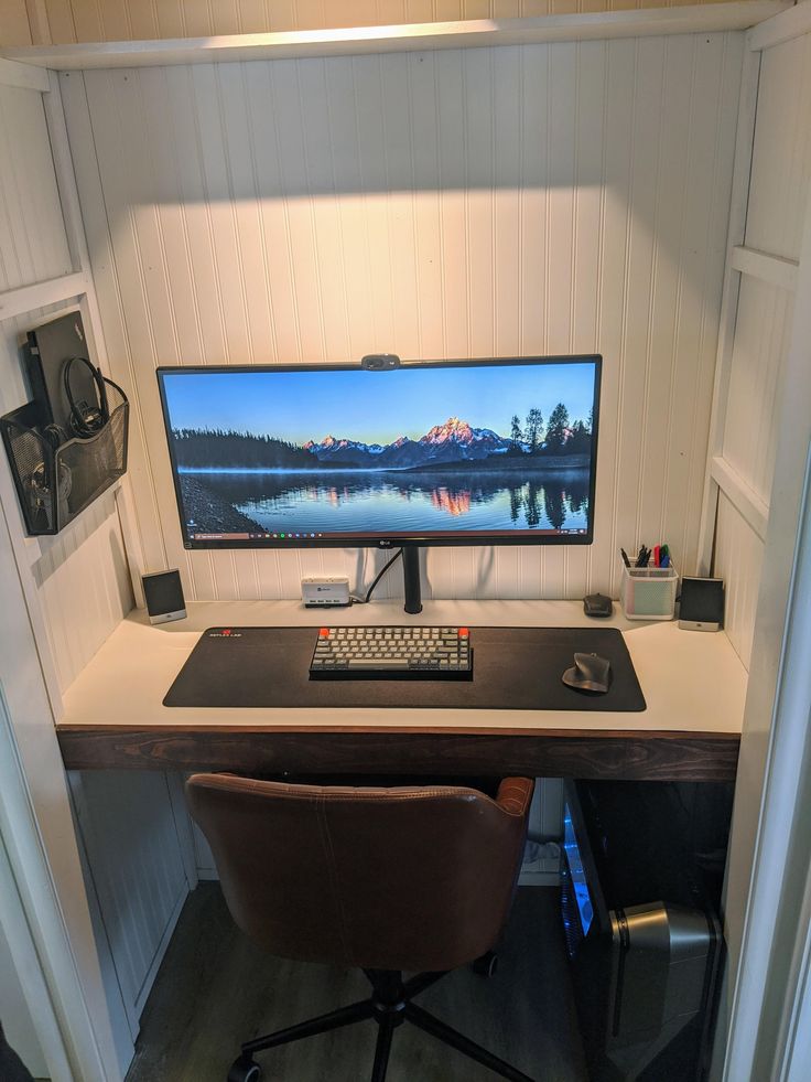 a computer desk with a keyboard, mouse and monitor sitting on it's side