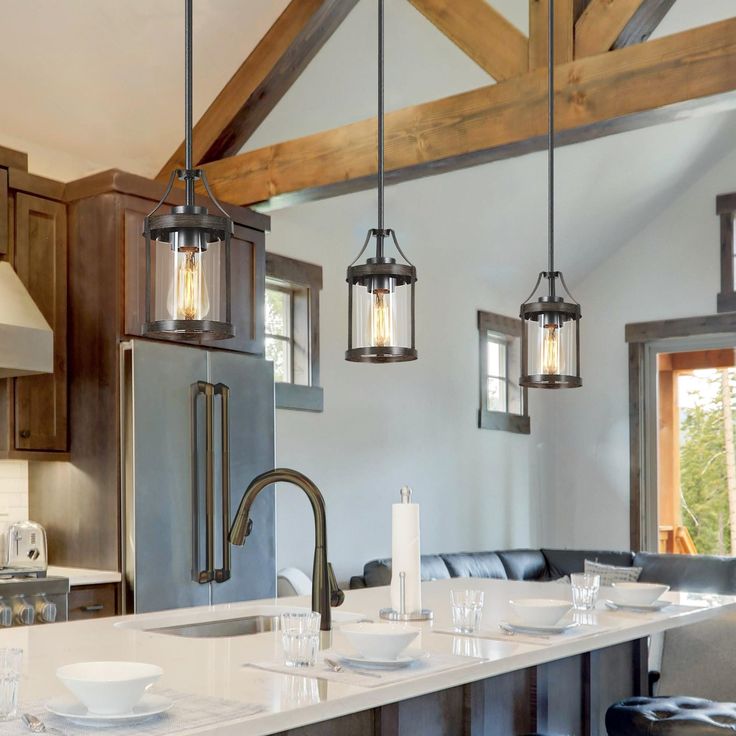 a kitchen with an island and two pendant lights