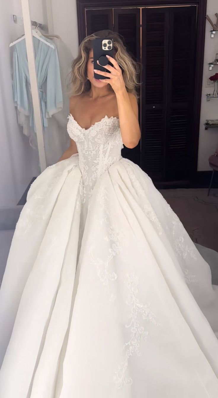 a woman taking a selfie in her wedding dress