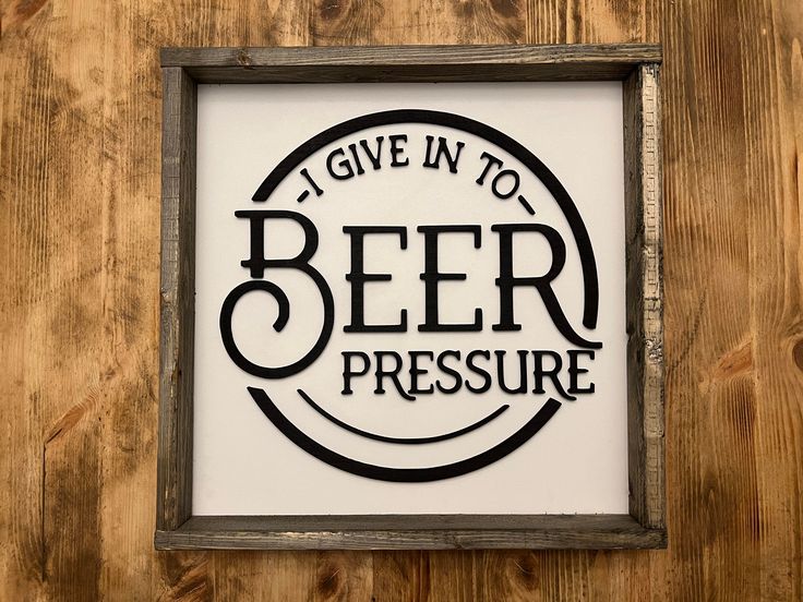 a sign that says i give in to beer pressure on the side of a wooden wall