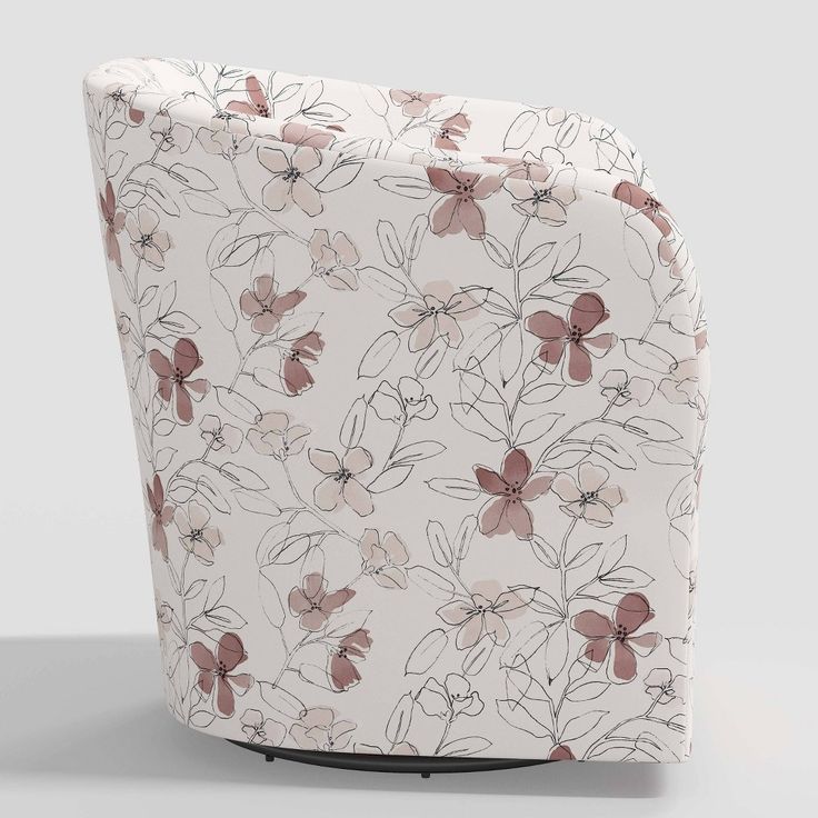 a white chair with pink and brown flowers on it's armrests, sitting in front of a gray background