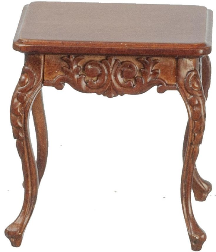 a small wooden table with carvings on the top and bottom edge, sitting against a white background