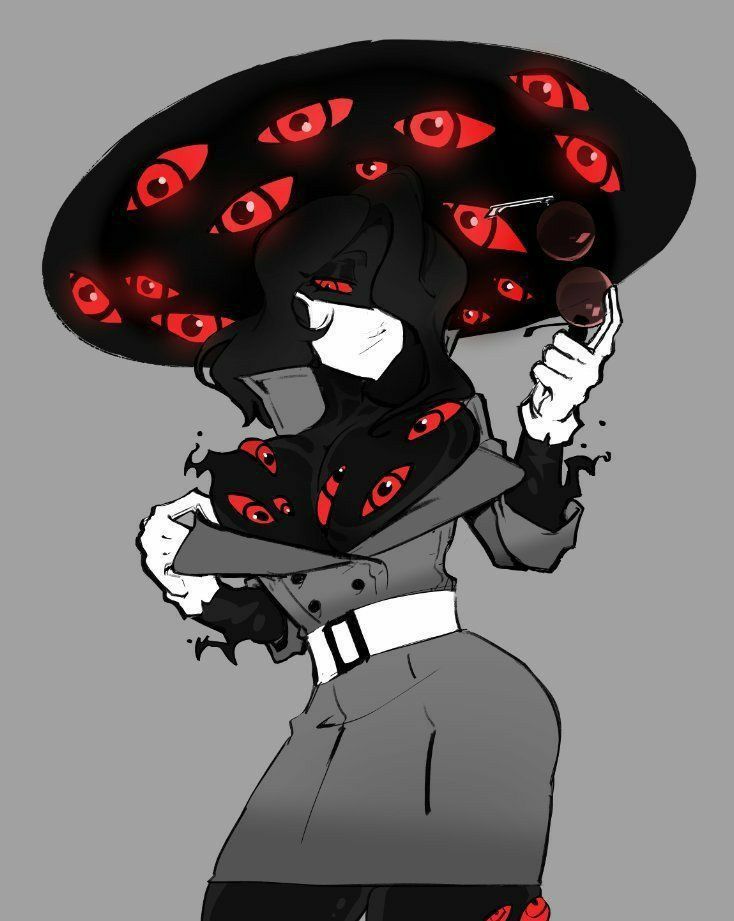 a woman wearing a black hat with red eyes on it