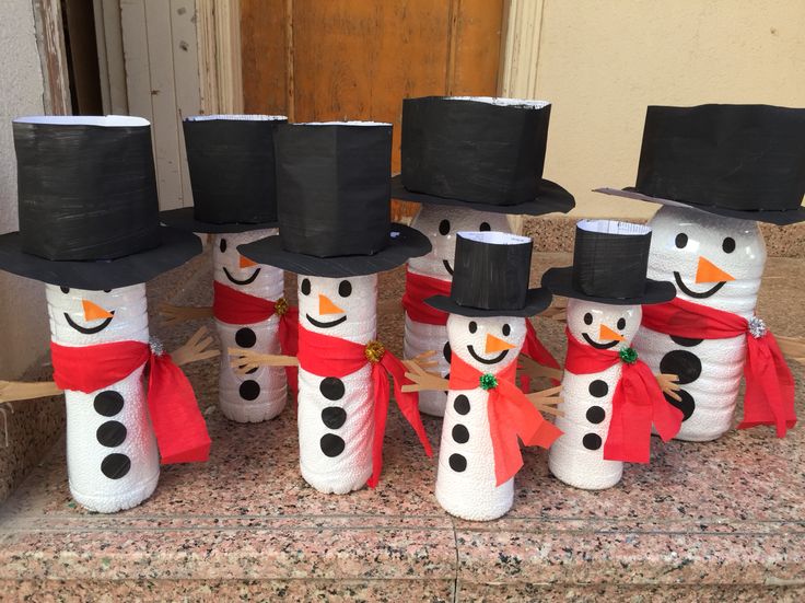 four snowmen wearing top hats and scarfs