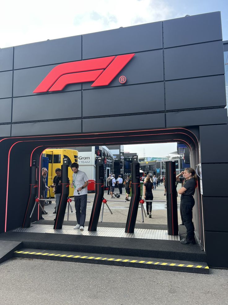 people are standing in the entrance to a race track