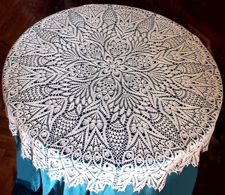 a white doily sitting on top of a wooden table