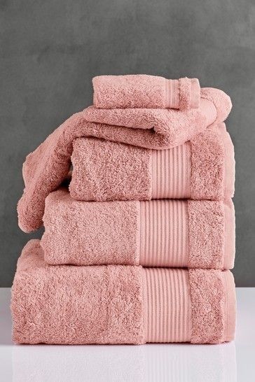 pink towels stacked on top of each other