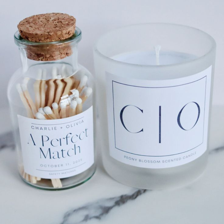 a glass jar filled with matches next to a candle