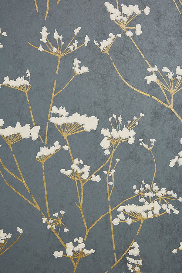 the wallpaper is decorated with white flowers and gold leaves on grey background, as well as metallic foil