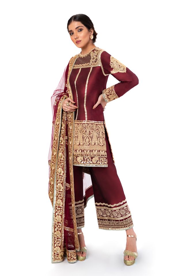 Maroon dupion silk kurta with gold tilla embroidery Paired with maroon dupion silk flared pants Comes with maroon net dupatta with badla embroidery This is a Three piece look. To customize, mail us at Manish Malhotra Suits, Manish Malhotra Dresses, Tilla Embroidery, Blue Sherwani, Trendy Outfits Indian, Pakistani Wedding Outfits, Custom Suits, Silk Kurta, Manish Malhotra