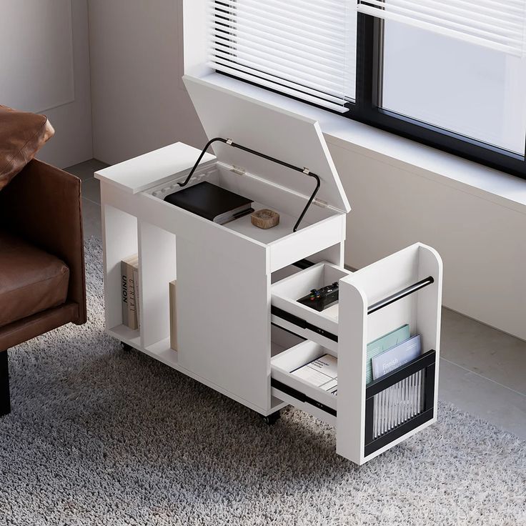 an open laptop computer sitting on top of a desk next to a brown leather chair