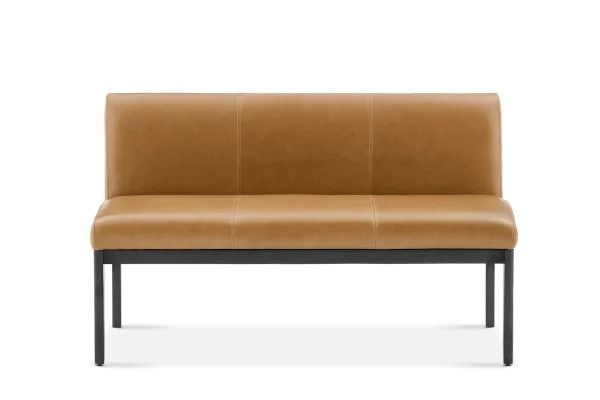 a brown leather bench sitting on top of a white floor