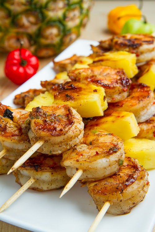 grilled shrimp and pineapple skewers on a white plate