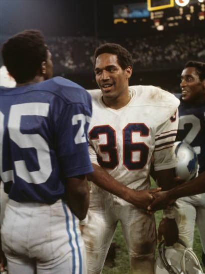 two football players talking to each other on the field