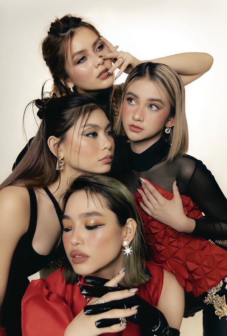 three models pose for the camera with their arms around each other and one is holding her head