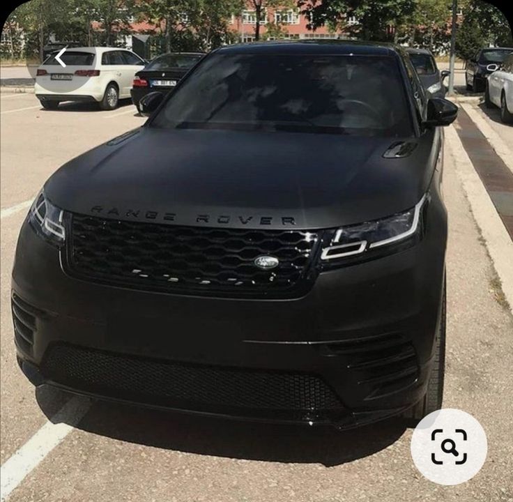 a black range rover parked in a parking lot