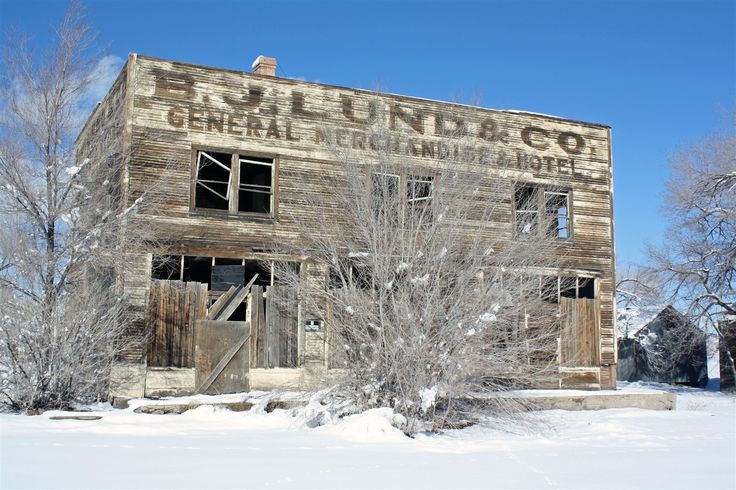 an old, run down building in the middle of winter with snow on the ground