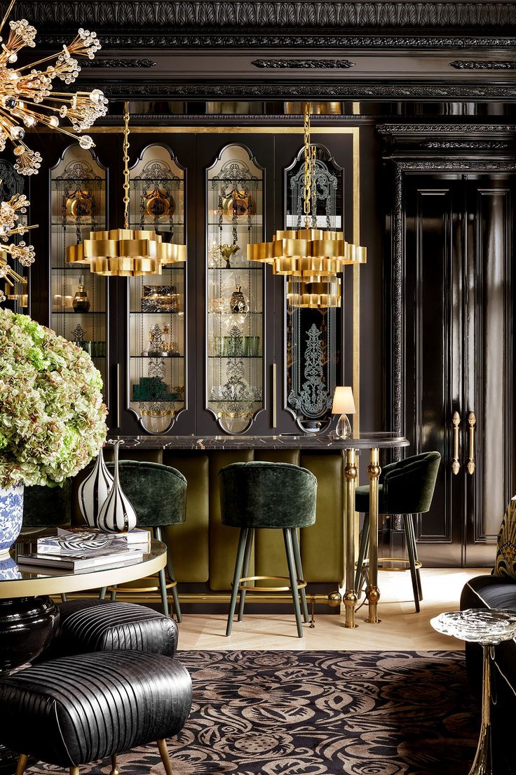 an elegant dining room with black and gold decor