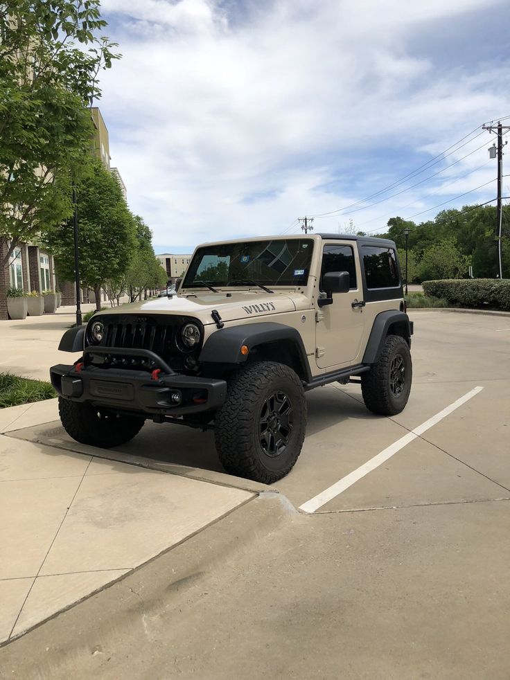 a white jeep parked in a parking lot