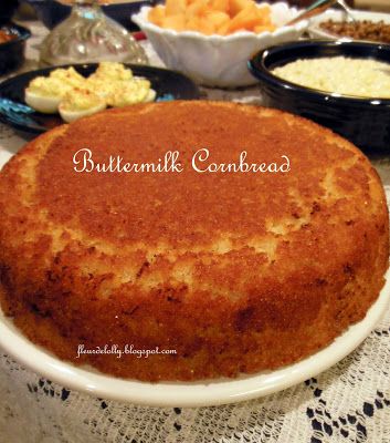 a cake sitting on top of a white plate next to bowls of macaroni and cheese