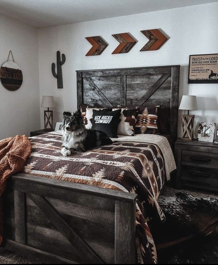 a dog sitting on top of a bed in a bedroom next to two wooden arrows