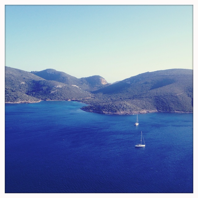 an aerial view of a sailboat in the water