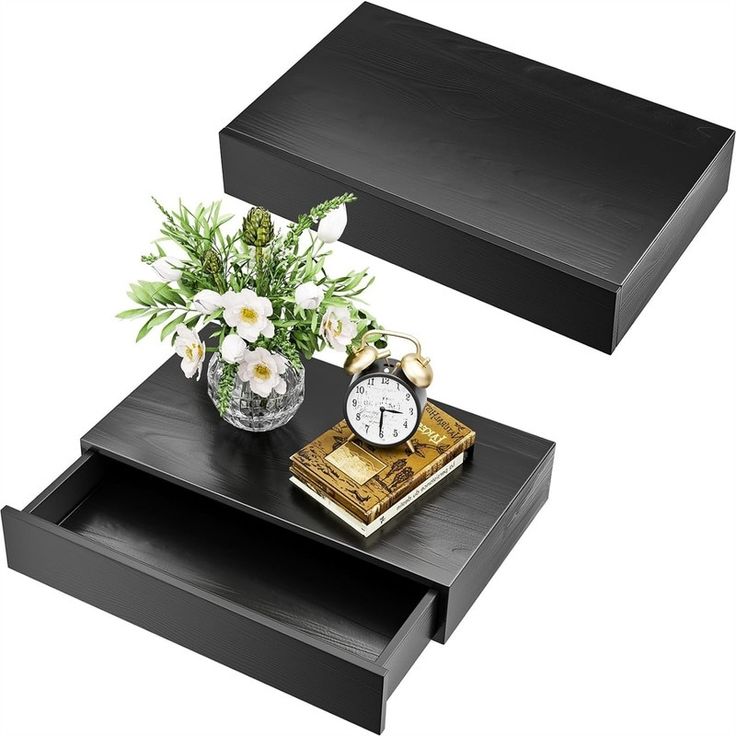 two black tables with flowers and an alarm clock