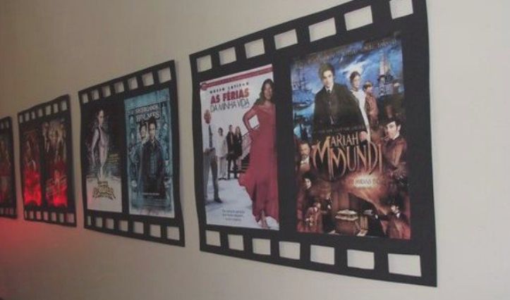 the movie posters are hanging on the wall