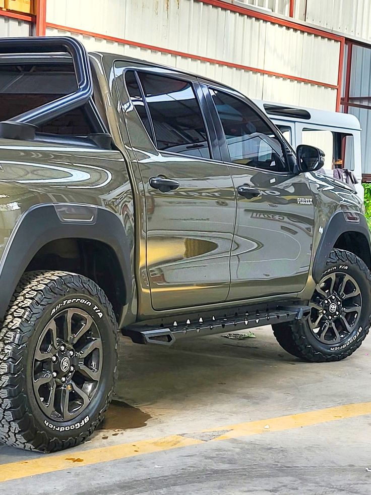 a silver truck parked in front of a building