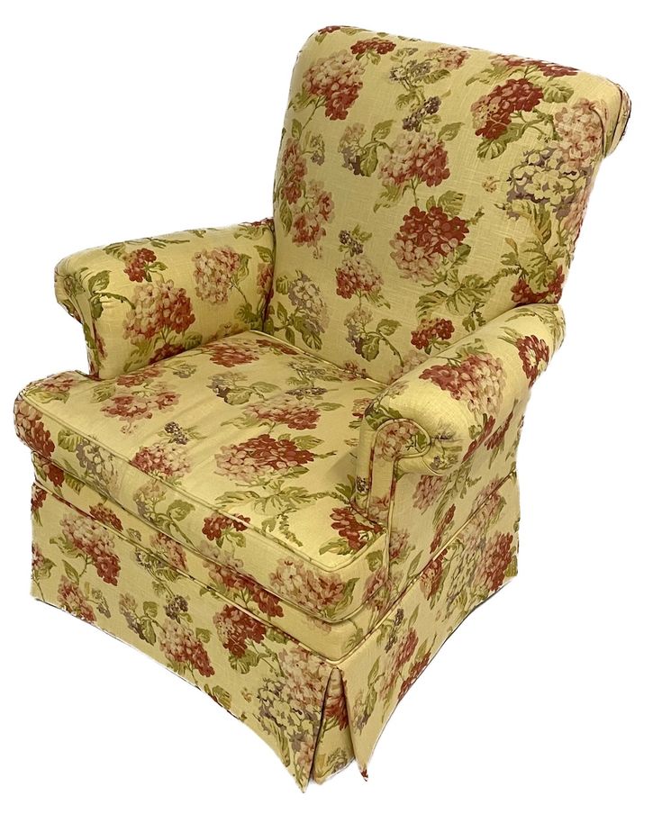 an upholstered chair with flowered fabric on the arms and back, sitting in front of a white background