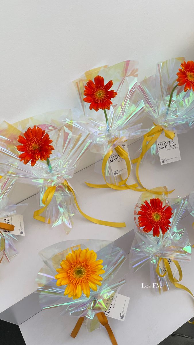 flowers are wrapped in cellophane and tied with ribbons