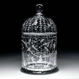 a glass birdcage with flowers and leaves on it's sides is shown against a black background