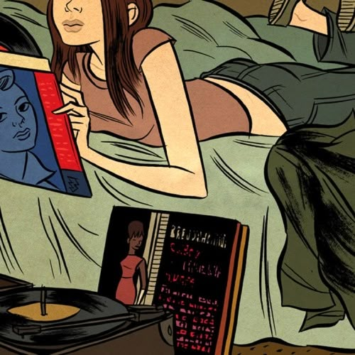 a woman laying in bed next to a record player