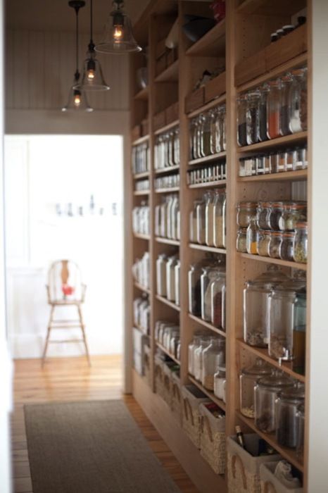 the pantry is filled with many jars and containers